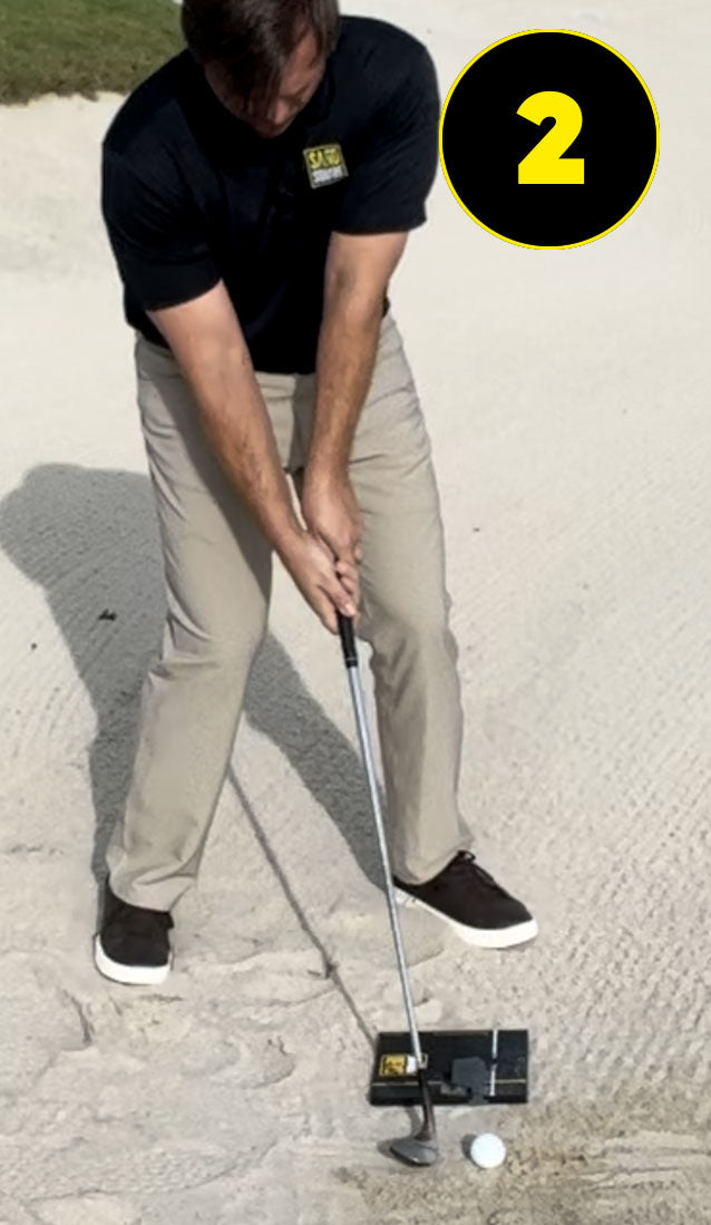 Address the golf ball for the sand shot with ball position off of lead foot