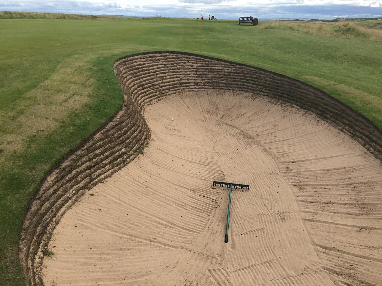 Golfer needs to execute a precise sand shot from a challenging sand trap, applying effective bunker shot techniques with focus on sand shot tips for improved performance on the golf course.