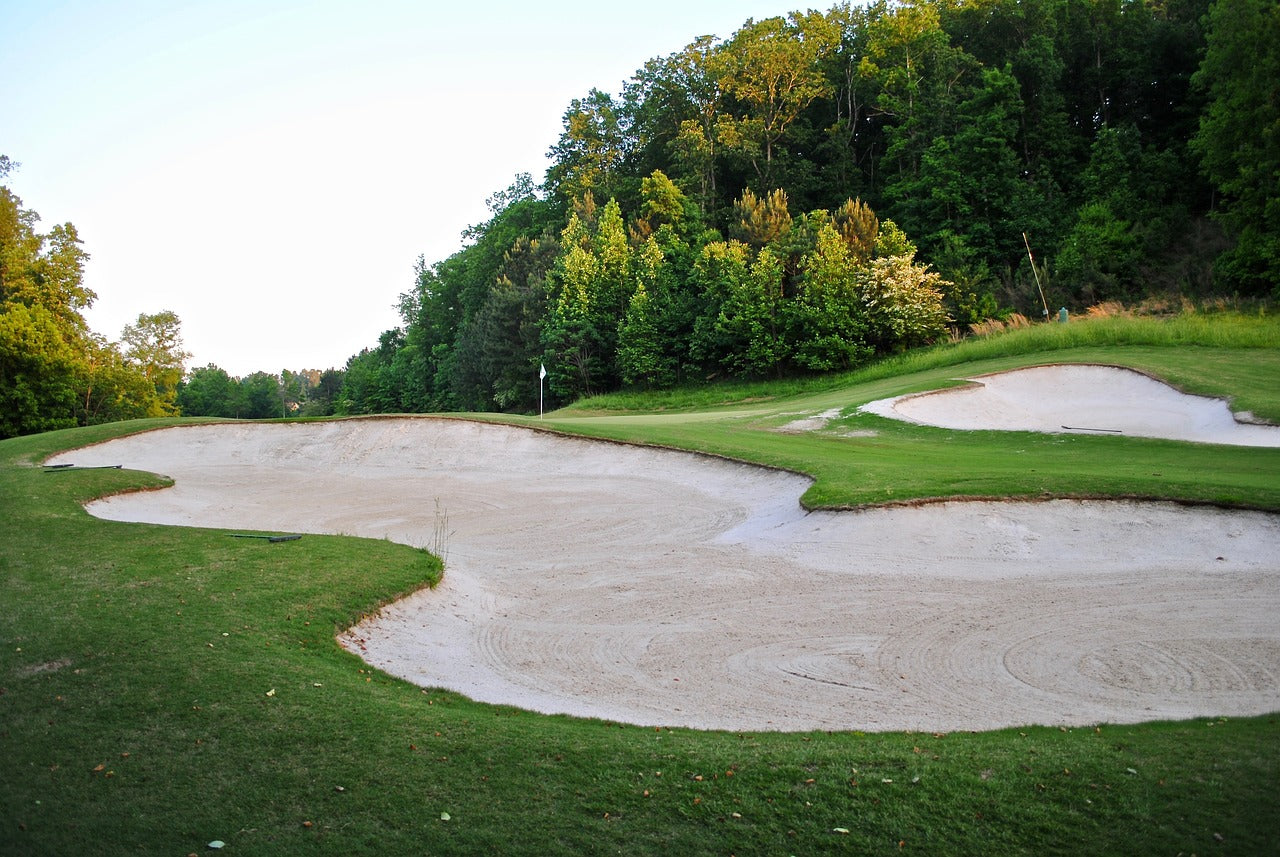 Expert golfer demonstrating how to hit a bunker shot with precision, showcasing essential sand shot tips and technique for mastering this challenging aspect of golf.