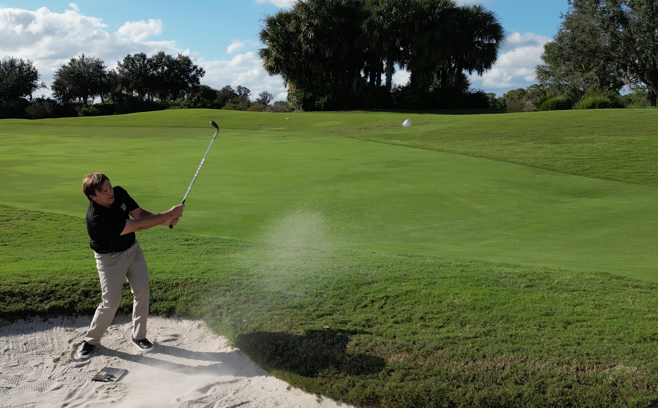 Hitting a sand shot with the Sand Square, a golf training aid for the sand shot